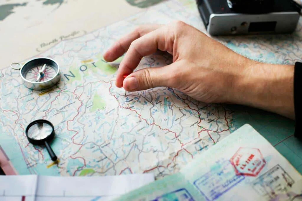 Closeup of hand pinning on world map journey travel