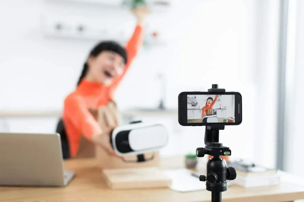 Caucasian female blogger joyfully unboxing new virtual reality headset online