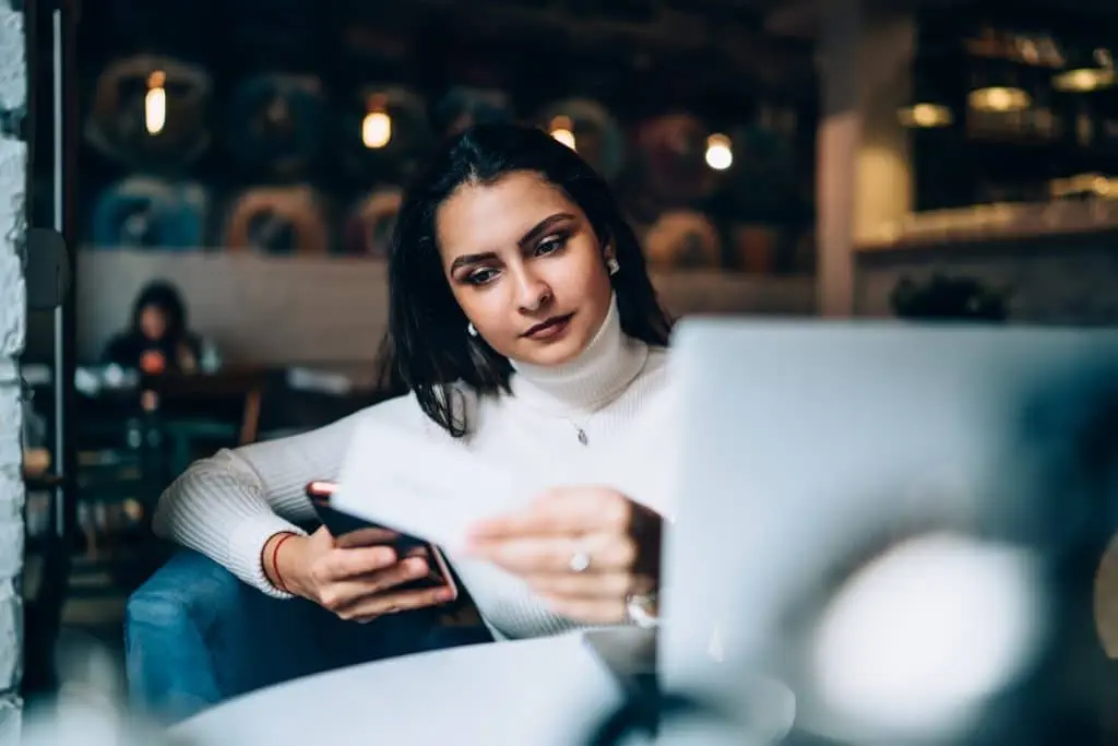 Digital Bussiness Cards digital business cards Woman texting on cellphone looking at business card